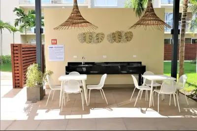 a restaurant with white tables and chairs and a piano at Blue Coast Apartment - Vibe Dominicus in La Laguna