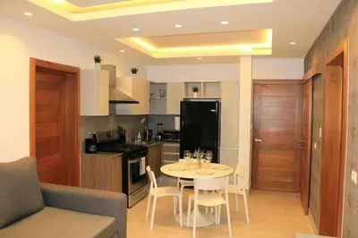 a kitchen and dining room with a table and chairs at Blue Coast Apartment - Vibe Dominicus in La Laguna