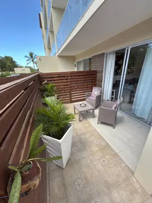 a patio with two chairs and a table on a house at Blue Coast Apartment - Vibe Dominicus in La Laguna