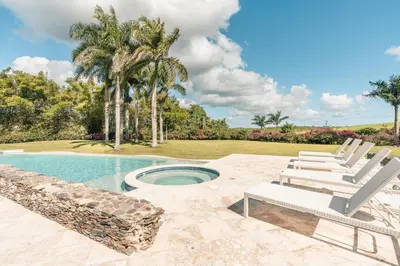 a patio with chairs and a swimming pool at Wonderful 1-BR apartment at Casa de Campo in El Infiernito
