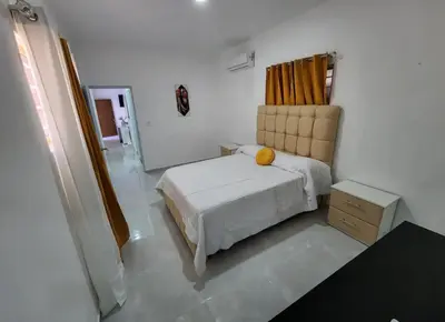a bedroom with a bed with a yellow pillow on it at Umbrella Street, city Center, close to many atracctions in San Felipe de Puerto Plata