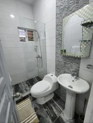 a bathroom with a toilet and a sink at Umbrella Street, city Center, close to many atracctions in San Felipe de Puerto Plata
