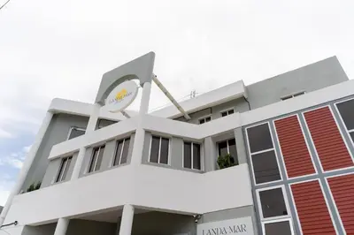 a white building with a clock on it at LANDA MAR BOCA CHICA in Boca Chica