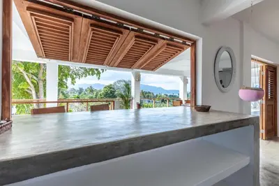 a kitchen with a large counter with a large window at Casa flor - 16 pax, vista al mar, 2 min de la playa in Las Galeras