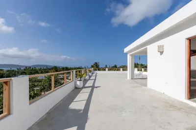 a balcony of a house with a view of the ocean at Casa flor - 16 pax, vista al mar, 2 min de la playa in Las Galeras