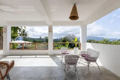 a room with a table and chairs and a large window at Casa flor - 16 pax, vista al mar, 2 min de la playa in Las Galeras