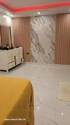 a hotel room with a bed and a marble wall at Obynb in Santo Domingo