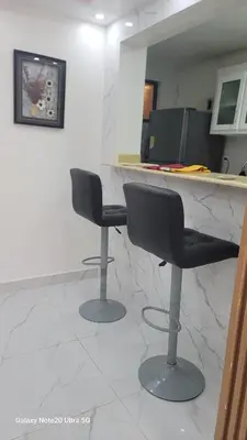 two bar stools in a room with a marble counter at Obynb in Santo Domingo