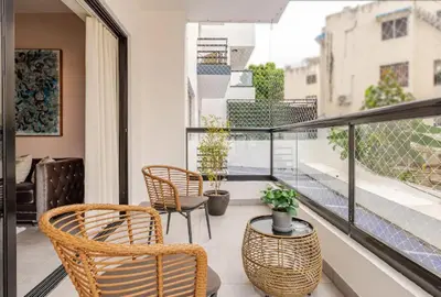 a balcony with two chairs and a table at Bella Vista cozy-deluxe near Downtown center in Santo Domingo