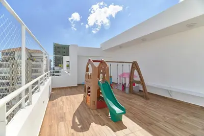 a balcony with a slide and a playground at Oasis Urbano Family 2br Pool Gym Lm22-8B in Santo Domingo