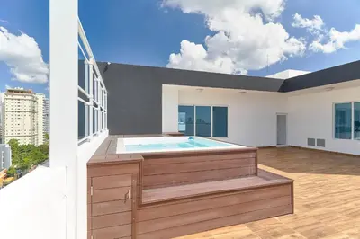 a hot tub on the balcony of a house at Oasis Urbano Family 2br Pool Gym Lm22-8B in Santo Domingo
