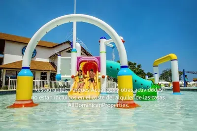 a water park with a water slide in the water at Ocean Villas, Campo Del Mar in Sosúa