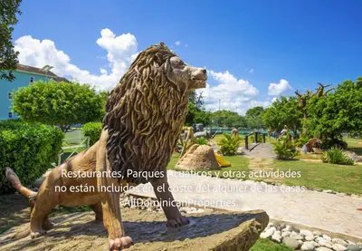 a statue of a bear sitting on a rock at Ocean Villas, Campo Del Mar in Sosúa
