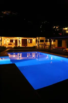 a large swimming pool lit up at night at Seaside villa with housekeeping staff - Las Terrenas in Las Terrenas