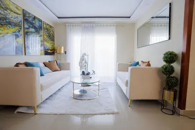 a living room with a couch and a table at Luxury Penthouse in San Francisco de Macorís