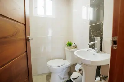 a bathroom with a toilet and a sink at Luxury Penthouse in San Francisco de Macorís