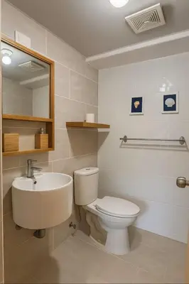 a bathroom with a toilet and a sink at Luxury Riviera Colonial, Santo Domingo in Santo Domingo