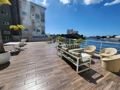 a patio with couches and chairs on top of a building at Luxury Riviera Colonial, Santo Domingo in Santo Domingo