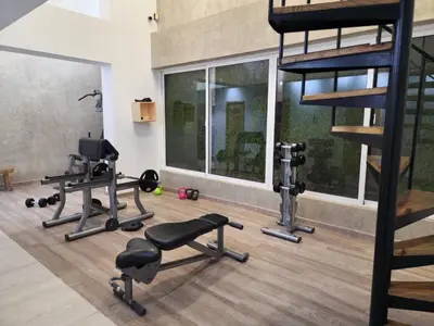a gym with two treadmills and two loft beds at Luxury Riviera Colonial, Santo Domingo in Santo Domingo