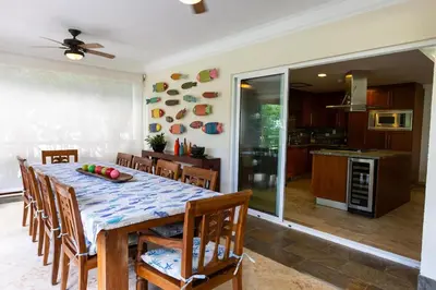 a kitchen and dining room with a table and chairs at Balcones Del Atlantic Beachfrontbbq in Las Terrenas
