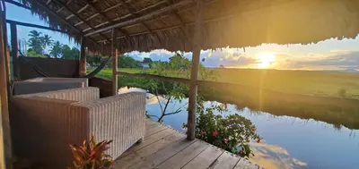 a house with a view of a river and the sunset at Mini Lodge in Cabarete