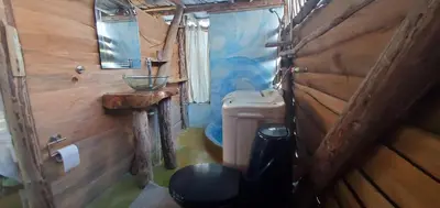 a small bathroom with a toilet and a sink at Mini Lodge in Cabarete