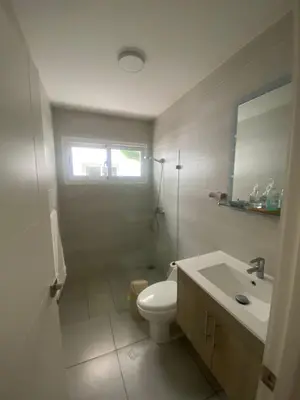 a white bathroom with a toilet and a sink at Vista Golf II Bahia Principe Playa-Nueva Romana in San Pedro de Macorís