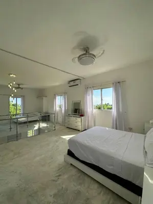 a large white bedroom with a bed and a desk at Casita Yanella in Cabrera