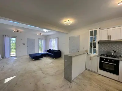 a large kitchen and living room with a blue couch at Casita Yanella in Cabrera
