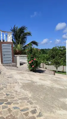 a house with a gate and a stone walkway at Apart Hotel Costa Verde - #2 Exclusivo y Seguro cama King zise in Las Galeras