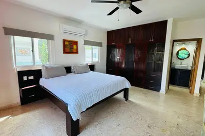 a bedroom with a bed and a ceiling fan at La Fenice Beachfront with King Beds in Las Terrenas