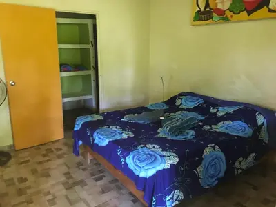 a bedroom with a bed with a blue comforter at Fata Morgana Eco Hotel in Las Terrenas