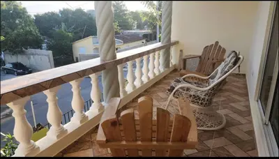 two chairs sitting on a balcony with a view at Casa Mami in Río San Juan