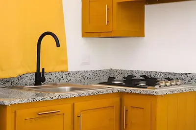 a kitchen with yellow cabinets and a sink at Apart Hotel Costa Verde#4 Exclusivo con cama Queen in Las Galeras