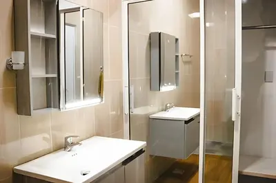 a bathroom with two sinks and a glass shower at Apart Hotel Costa Verde#4 Exclusivo con cama Queen in Las Galeras