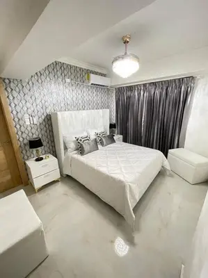 a bedroom with a large white bed and a window at Torre Sophia Monserrat in Los Frailes
