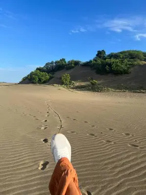 a person walking on the sand with a trail at Casa Zanelli, lugar de paz… in Baní