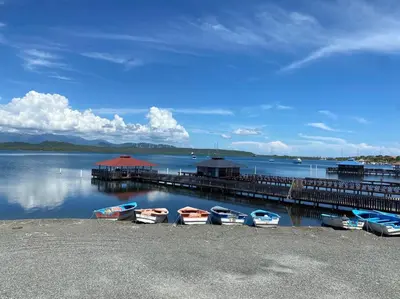 a group of boats are docked at a dock at Casa Zanelli, lugar de paz… in Baní