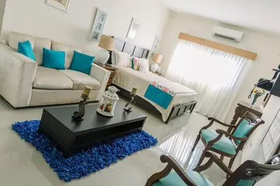 a living room with a couch and a table at Guacamayos Hotel in Bonao