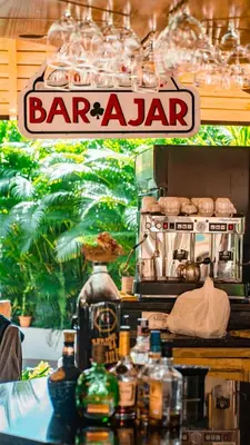 a baroda sign on top of a table with drinks at Guacamayos Hotel in Bonao