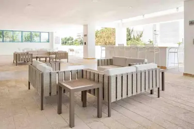 a room with tables and couches in a building at Juan Dolio, Beach Access 2 BR Apt Salitre Tower front of Club Hemingway in Juan Dolio
