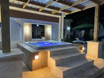 a jacuzzi tub on a patio at night at Villas Carela in Cabarete