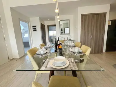 a dining room with a glass table and chairs at Cana Pearl Penthouse, Hard Rock Golf & Casino in Punta Cana