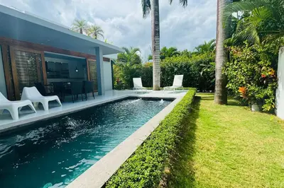 a swimming pool in the backyard of a house at Private Garden Villa With Parking in Las Terrenas