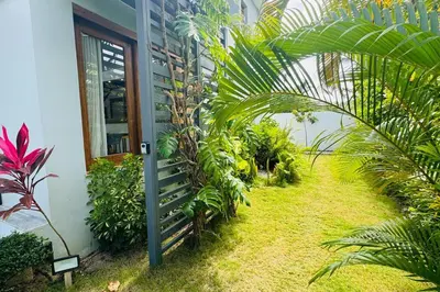 a garden outside a house with palm trees at Private Garden Villa With Parking in Las Terrenas