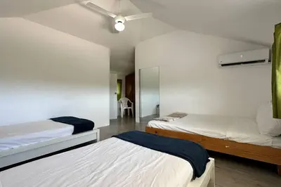 a bedroom with two beds and a ceiling fan at La Fenice Beachfront 3 Bedroom With Parking in Las Terrenas