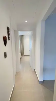 a hallway with white walls and a white hallway with at Tropical Caribbean space with 2 bedrooms C3 in Punta Cana