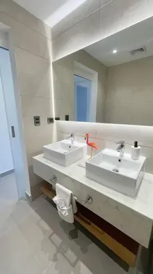 a bathroom with two sinks and a large mirror at Tropical Caribbean space with 2 bedrooms C3 in Punta Cana