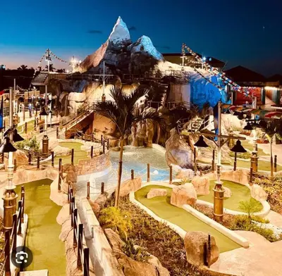 a water park with a mountain in the background at beautiful beachfront complex with 2 pools, free wifi, free beach chairs in Punta Cana
