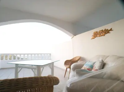 a living room with a couch and a table at Immaculate 1-Bed Apartment in Cofresi in Las Flores